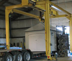 out building being loaded on semi trailer from overhead crane